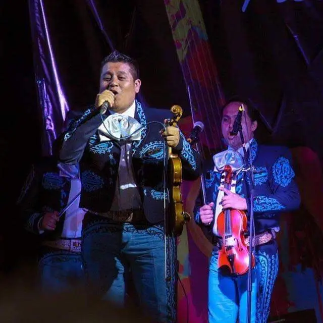 Integrantes de Mariachi Playense con traje bordado azul en concierto